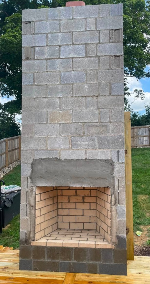Outdoor wood-burning fireplace built in block with a firebrick firebox