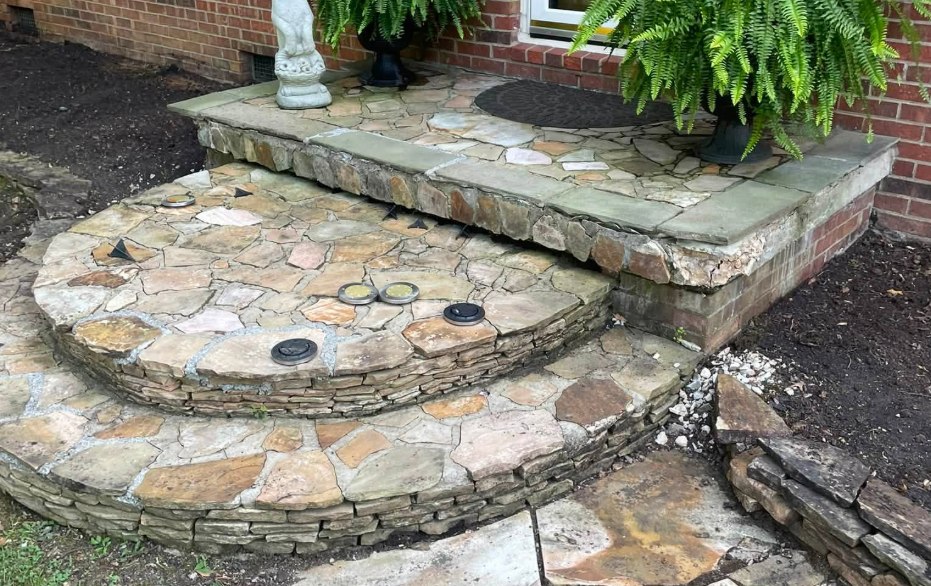 Curved flagstone steps and landing with lights set into the tread