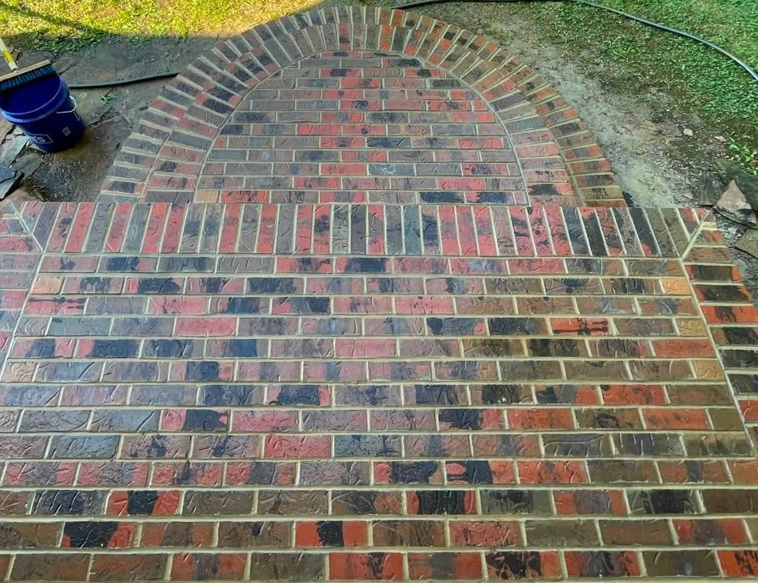 Brick landing with a radial arched fan pattern laid into the field
